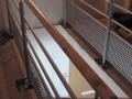 Escalier sur double crémaillère centrale en érable vernis incolore et garde-corps en acier laqué.